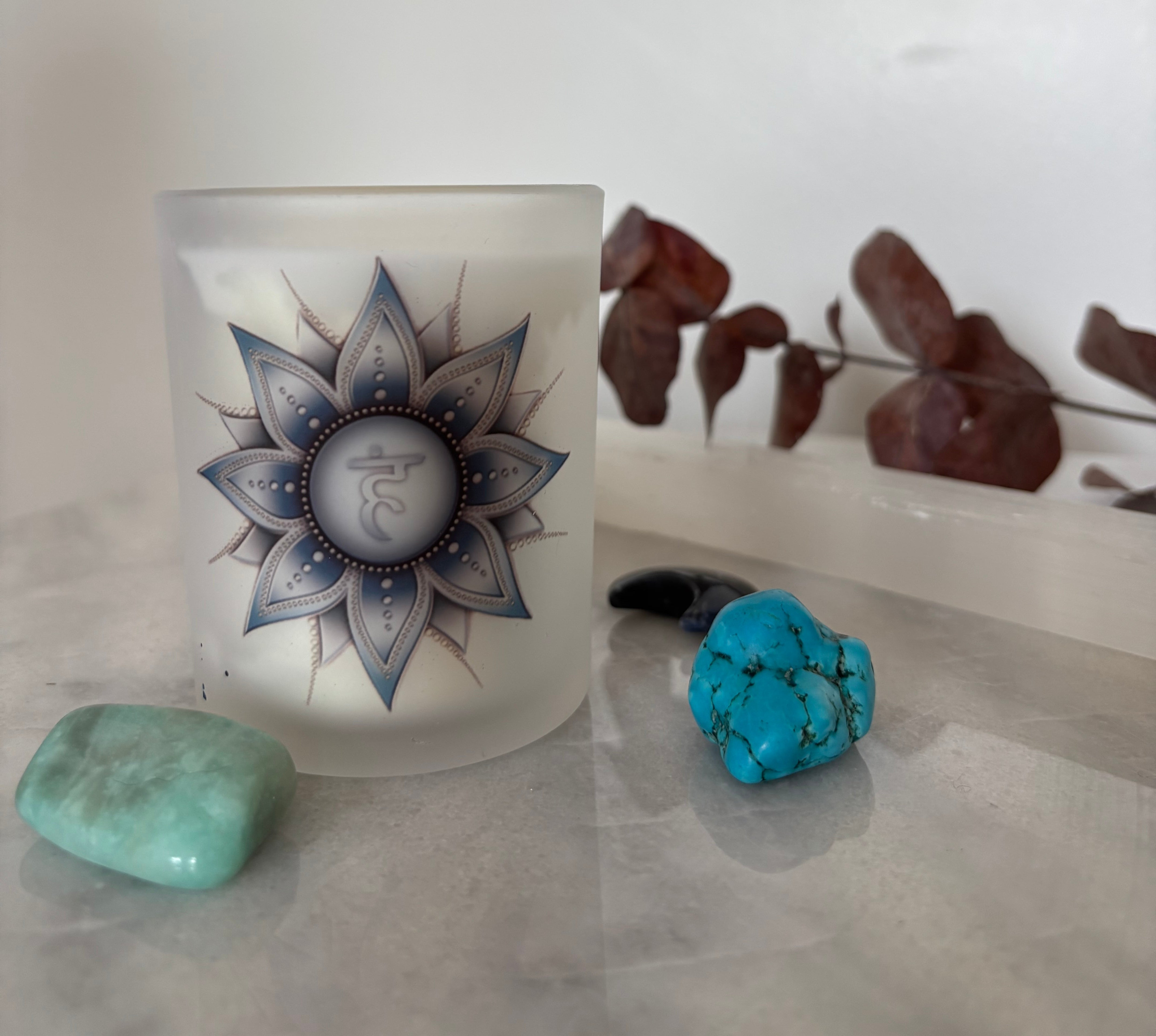 scentia essential oil scented candle surrounded by crystals